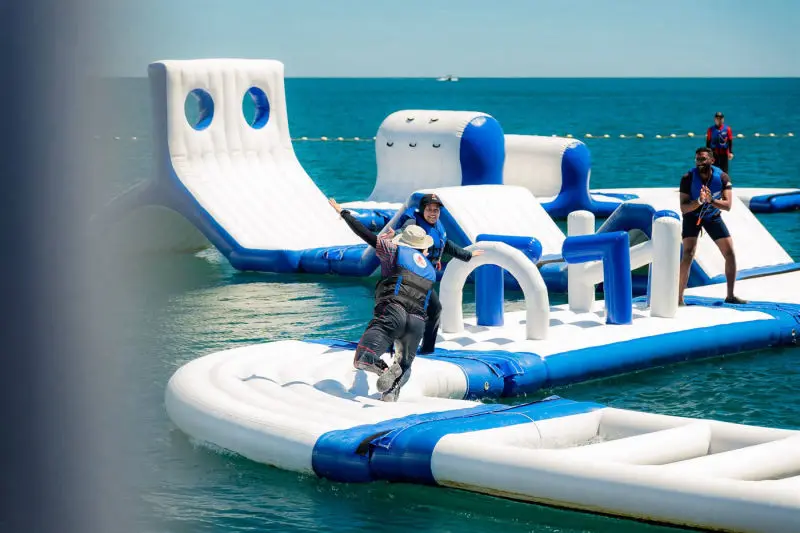 people play at inflatable water park