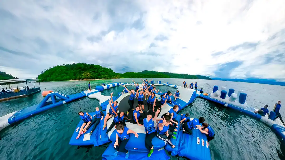 Group of people enjoying water activities at a floating park in Kota Kinabalu